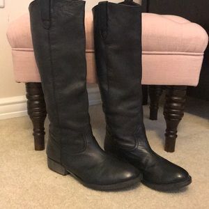 Tall black leather riding boots